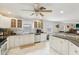 Bright kitchen featuring white cabinetry, granite countertops, stainless steel appliances and tiled floors at 3176 Duane Ave, Oldsmar, FL 34677
