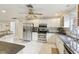 Modern kitchen featuring stainless steel appliances, granite counters, and white cabinetry at 3176 Duane Ave, Oldsmar, FL 34677