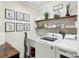 Cozy laundry room with modern appliances, decorative wall art, and ample shelving for storage at 3176 Duane Ave, Oldsmar, FL 34677