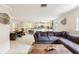 Open-concept living room with tile flooring, modern decor, and a view of the kitchen at 3176 Duane Ave, Oldsmar, FL 34677