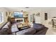 Spacious living room with modern fireplace, mounted TV, and access to the dining area at 3176 Duane Ave, Oldsmar, FL 34677