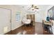 Well-lit office space featuring a unique chair, multiple windows, and stylish hardwood floors at 3176 Duane Ave, Oldsmar, FL 34677
