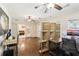 Spacious home office with hardwood floors, modern furniture, and access to living area at 3176 Duane Ave, Oldsmar, FL 34677