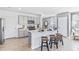 Open kitchen with stainless steel appliances, a center island and three bar stools at 33091 Osprey Peak Way, San Antonio, FL 33576