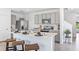 Open kitchen with stainless steel appliances, island with bar seating, and pendant lighting at 33091 Osprey Peak Way, San Antonio, FL 33576
