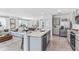 Open-concept living and dining room featuring stainless steel kitchen appliances and plenty of natural light at 33091 Osprey Peak Way, San Antonio, FL 33576