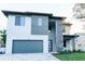 Modern two-story home with a gray color scheme, a two-car garage, and a well-manicured front yard at 3310 W Rogers Ave, Tampa, FL 33611