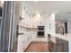 Spacious kitchen with white cabinets, stainless steel appliances, and a kitchen island with a sink at 3310 W Rogers Ave, Tampa, FL 33611