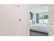 Bright tiled shower and view into the main bedroom with blue accent wall at 33126 Osprey Peak Way, San Antonio, FL 33576