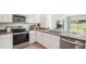 Bright kitchen featuring stainless steel appliances, sleek countertops, and modern white cabinets at 33126 Osprey Peak Way, San Antonio, FL 33576