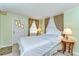 Cozy bedroom featuring neutral tones, windows providing natural light, and a private entrance at 35128 Dale Ave, Zephyrhills, FL 33541
