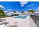 Community pool featuring black fencing and lounge chairs at Zephyr Shores at 35128 Dale Ave, Zephyrhills, FL 33541