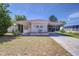 Inviting single-story home with a carport, featuring colorful shutters and a tidy front yard at 35128 Dale Ave, Zephyrhills, FL 33541
