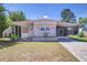 Cozy single-story home with a covered carport, charming shutters, and a well-maintained lawn at 35128 Dale Ave, Zephyrhills, FL 33541