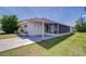 Single-story home featuring a large screened-in porch, creating an ideal outdoor living space at 35128 Dale Ave, Zephyrhills, FL 33541