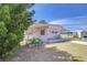 Quaint home with colorful shutters and covered parking, nestled among lush greenery and a manicured lawn at 35128 Dale Ave, Zephyrhills, FL 33541