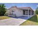 Charming single-story home with a long screened-in porch and well-manicured lawn at 35128 Dale Ave, Zephyrhills, FL 33541