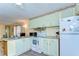 Functional kitchen with pastel cabinets, updated appliances, and ample counter space at 35128 Dale Ave, Zephyrhills, FL 33541