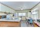 Charming kitchen boasts ample cabinetry, modern appliances, and a breakfast nook with a white table and blue chairs at 35128 Dale Ave, Zephyrhills, FL 33541