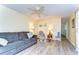 Open living room featuring wood-look flooring, neutral walls, and an inviting seating arrangement at 35128 Dale Ave, Zephyrhills, FL 33541