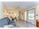 Comfortable living room with wood-look flooring, soft lighting, and access to outdoor space at 35128 Dale Ave, Zephyrhills, FL 33541