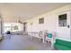 Inviting porch with seating, ceiling fan, and screened enclosure, perfect for relaxation and enjoying the outdoors at 35128 Dale Ave, Zephyrhills, FL 33541