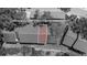 A gray filter aerial shot highlights a condo with trees and some grass at 3600 Magnolia Ridge Cir # 1221-G, Palm Harbor, FL 34684