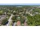 Expansive aerial view of a residential community with lush greenery and a glimpse of a serene lake in the distance at 3600 Magnolia Ridge Cir # 1221-G, Palm Harbor, FL 34684