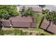 Aerial view of roofs and trees with some grass at 3600 Magnolia Ridge Cir # 1221-G, Palm Harbor, FL 34684