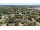 An aerial view showcases the community with lush greenery and winding roads at 3600 Magnolia Ridge Cir # 1221-G, Palm Harbor, FL 34684