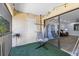 Relaxing balcony with hammock chairs, string lights, artificial grass, and sliding door to living room at 3600 Magnolia Ridge Cir # 1221-G, Palm Harbor, FL 34684