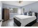 Bedroom with wood-look flooring, ceiling fan, and large windows for natural light at 3600 Magnolia Ridge Cir # 1221-G, Palm Harbor, FL 34684