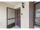 Condo front door with screen, doorbell, and light at 3600 Magnolia Ridge Cir # 1221-G, Palm Harbor, FL 34684