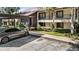 Well-maintained condo exterior featuring a private balcony and verdant landscaping at 3600 Magnolia Ridge Cir # 1221-G, Palm Harbor, FL 34684