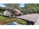 Charming exterior view of a residential building with a carport and lush, green landscaping at 3600 Magnolia Ridge Cir # 1221-G, Palm Harbor, FL 34684