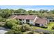 A partially-framed aerial shot showcases a condo exterior with a balcony and access to nearby carport at 3600 Magnolia Ridge Cir # 1221-G, Palm Harbor, FL 34684