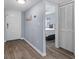 Hallway with wood flooring, large closet, and view into the primary bedroom at 3600 Magnolia Ridge Cir # 1221-G, Palm Harbor, FL 34684