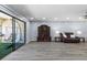 Open living room with hardwood floors, modern decor, and access to balcony with hammock chairs at 3600 Magnolia Ridge Cir # 1221-G, Palm Harbor, FL 34684
