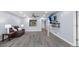 Spacious living room featuring updated flooring, modern shelving, and comfortable seating with neutral paint at 3600 Magnolia Ridge Cir # 1221-G, Palm Harbor, FL 34684