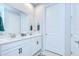 Bright bathroom with double vanity, granite counters and modern fixtures at 3765 Maxwell Park Dr, Sun City Center, FL 33573