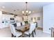 Dining room with chandelier lighting, seating for six, and kitchen in background at 3765 Maxwell Park Dr, Sun City Center, FL 33573