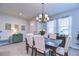 Elegant dining room with modern chandelier and comfortable seating, adjacent to foyer at 3765 Maxwell Park Dr, Sun City Center, FL 33573