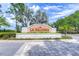 Elegant community entrance sign 'La Paloma' with well-maintained landscaping and brick-paved road at 3765 Maxwell Park Dr, Sun City Center, FL 33573