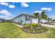 Charming single-story home with a well-manicured lawn and colorful flower beds at 3765 Maxwell Park Dr, Sun City Center, FL 33573