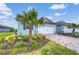 Charming home exterior featuring a well-manicured front yard, brick paved driveway, and a light-blue facade at 3765 Maxwell Park Dr, Sun City Center, FL 33573