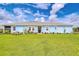 Inviting single-story home featuring a well-kept lawn and colorful flower beds accentuating the façade at 3765 Maxwell Park Dr, Sun City Center, FL 33573