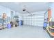 Spacious two car garage, featuring a clean epoxy floor, and ample space for storage at 3765 Maxwell Park Dr, Sun City Center, FL 33573