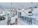 Spacious kitchen and dining area with modern appliances, white cabinetry, and barstool seating at 3765 Maxwell Park Dr, Sun City Center, FL 33573