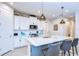 Bright and modern kitchen with a spacious island and stylish pendant lighting at 3765 Maxwell Park Dr, Sun City Center, FL 33573