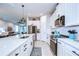 Well-equipped kitchen with stainless appliances, white cabinets, and quartz countertop at 3765 Maxwell Park Dr, Sun City Center, FL 33573